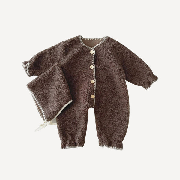 Pensé pour l’hiver, notre pyjama bébé sans pied en teinte chocolat enveloppe votre tout-petit de chaleur et de douceur, fidèle à l’univers cosy de Bellemoon.